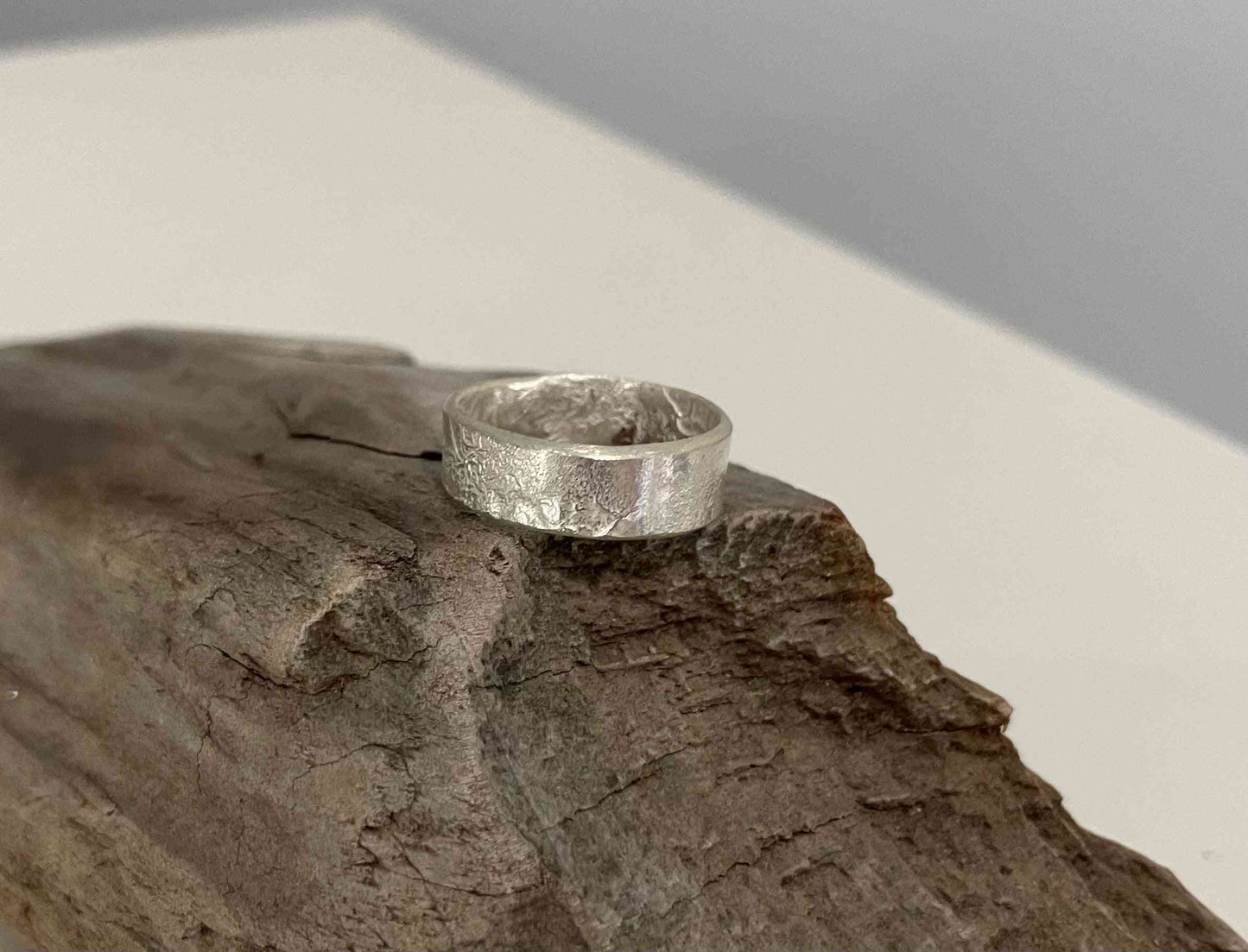 Reticulated Silver Ring - Size 7 with unique textured finish, displayed on rustic wood. Handcrafted for a bold, artisanal jewelry statement.