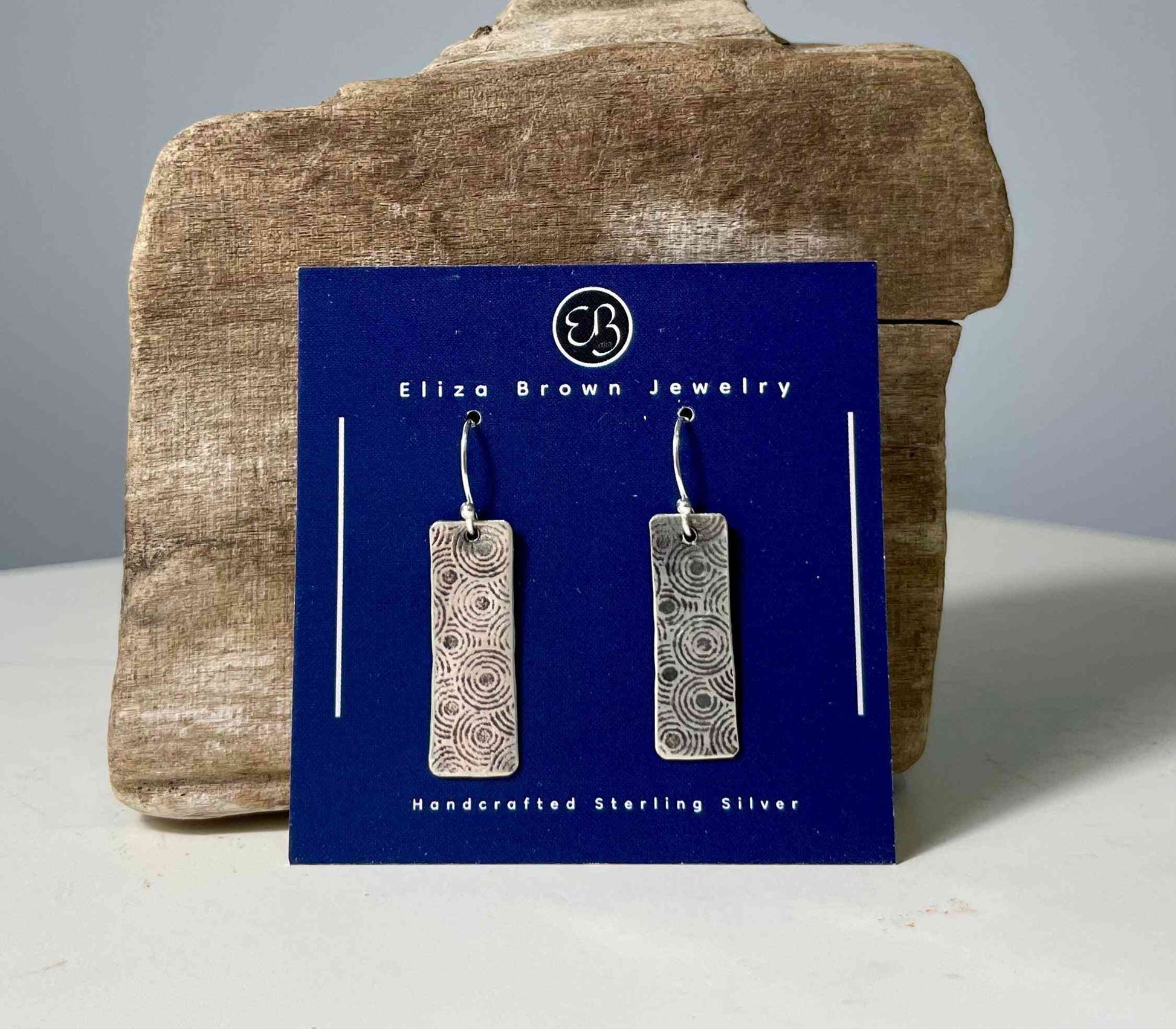 Sterling silver earrings with circle pattern by Eliza Brown Jewelry, rectangular handcrafted dangles with patina finish, perfect for versatile styling.