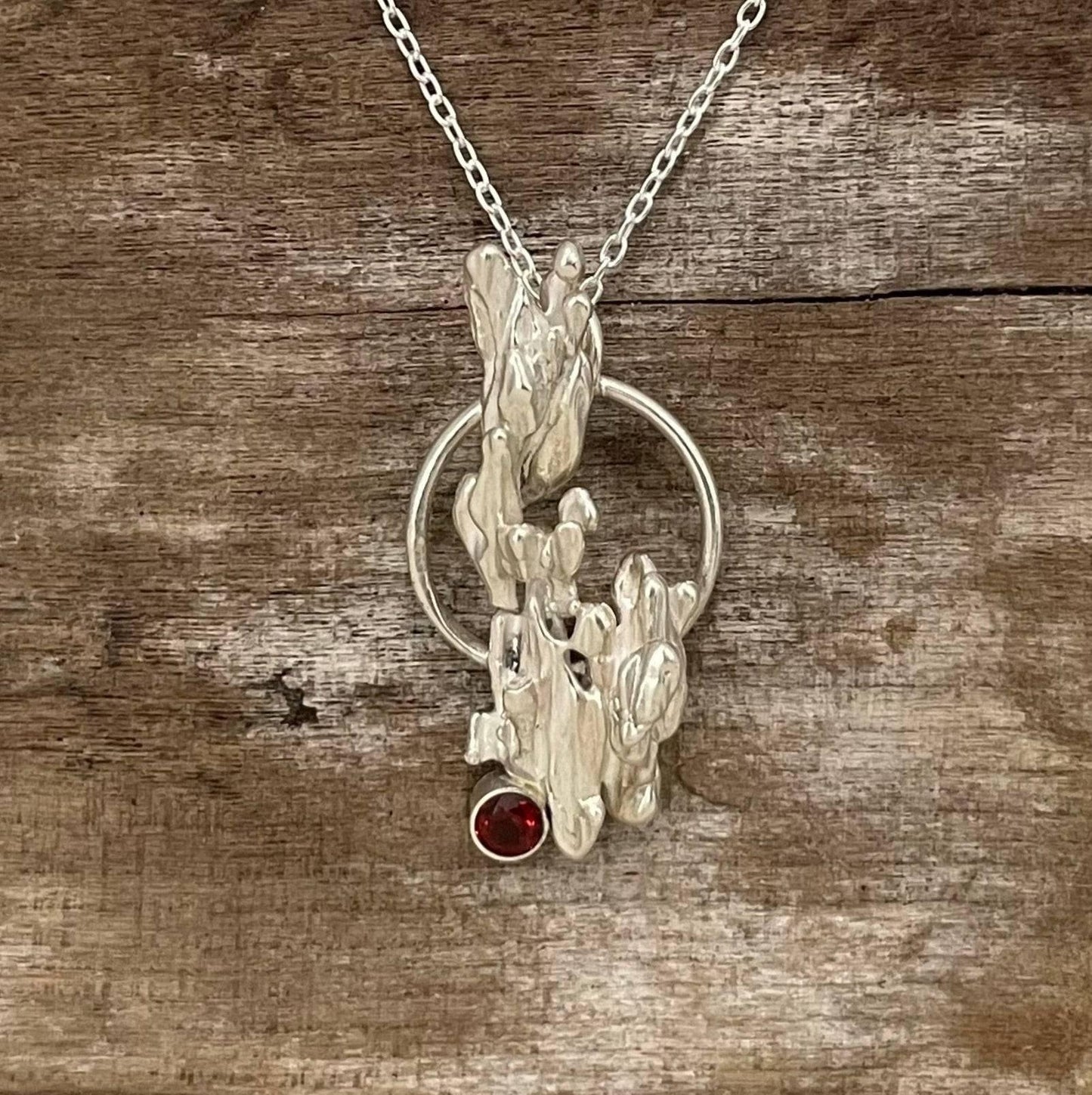 Handcrafted broom casted drippy silver necklace with garnet. one of a kind