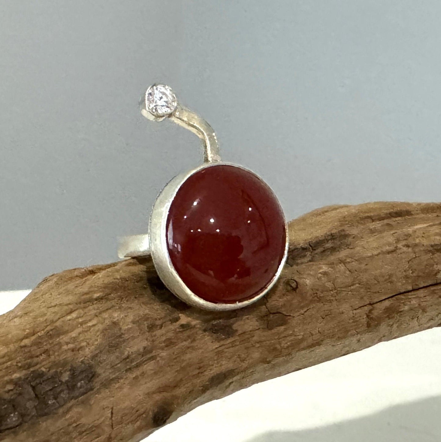 unique design of a silver ring with red jaspers and clear quartz. handcrafted