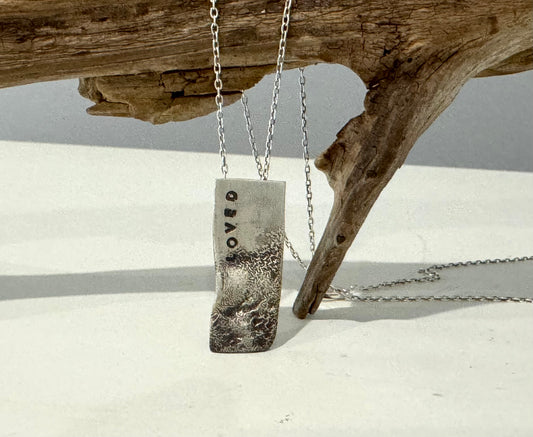 LOVED stamped silver pendant