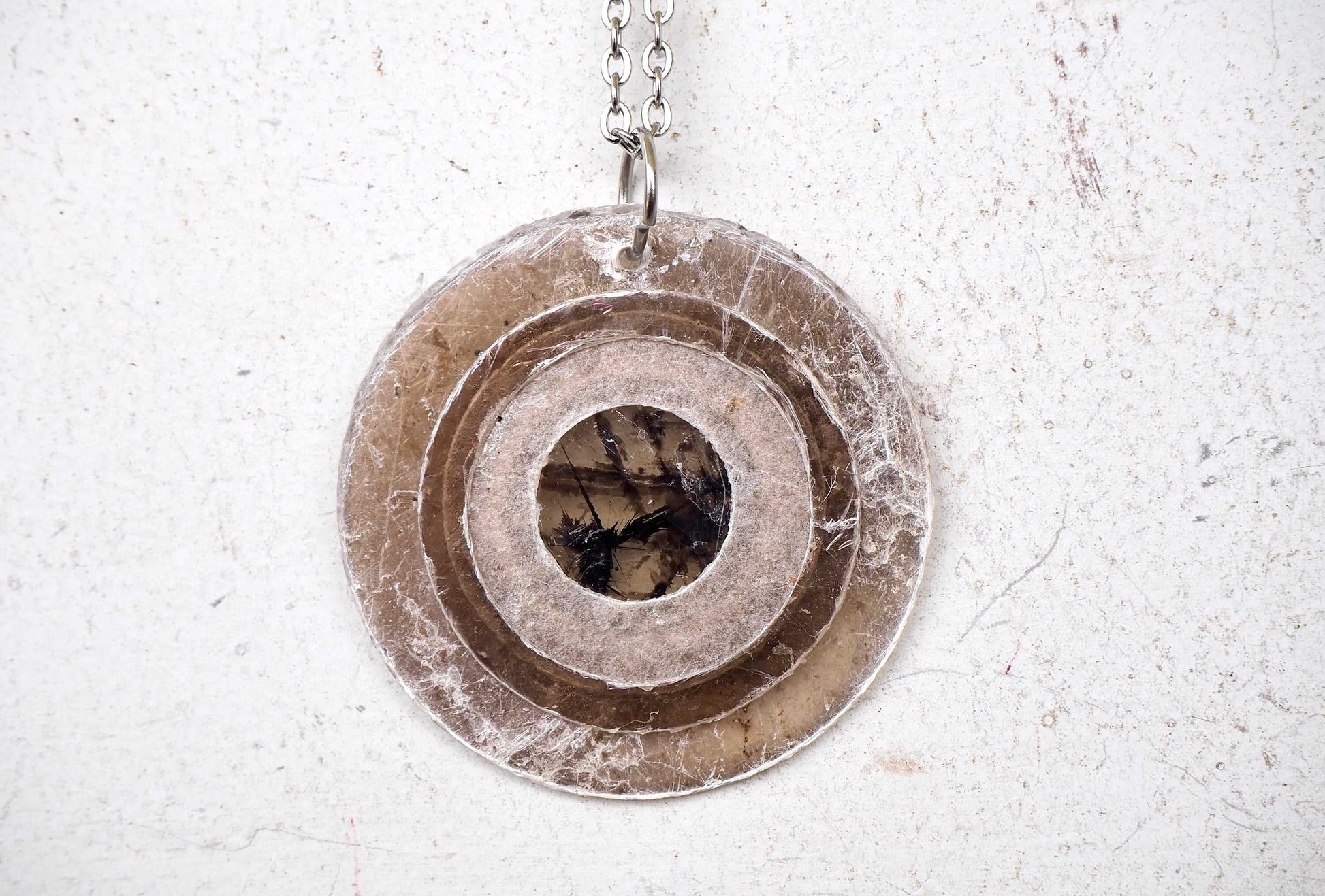 Mica pendant with chain in a circular design