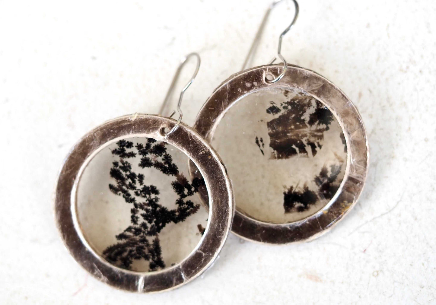 Mica earrings with black pattern in a circular design