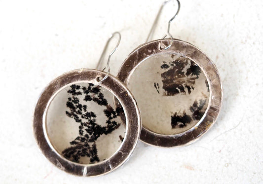 Mica earrings with black pattern in a circular design